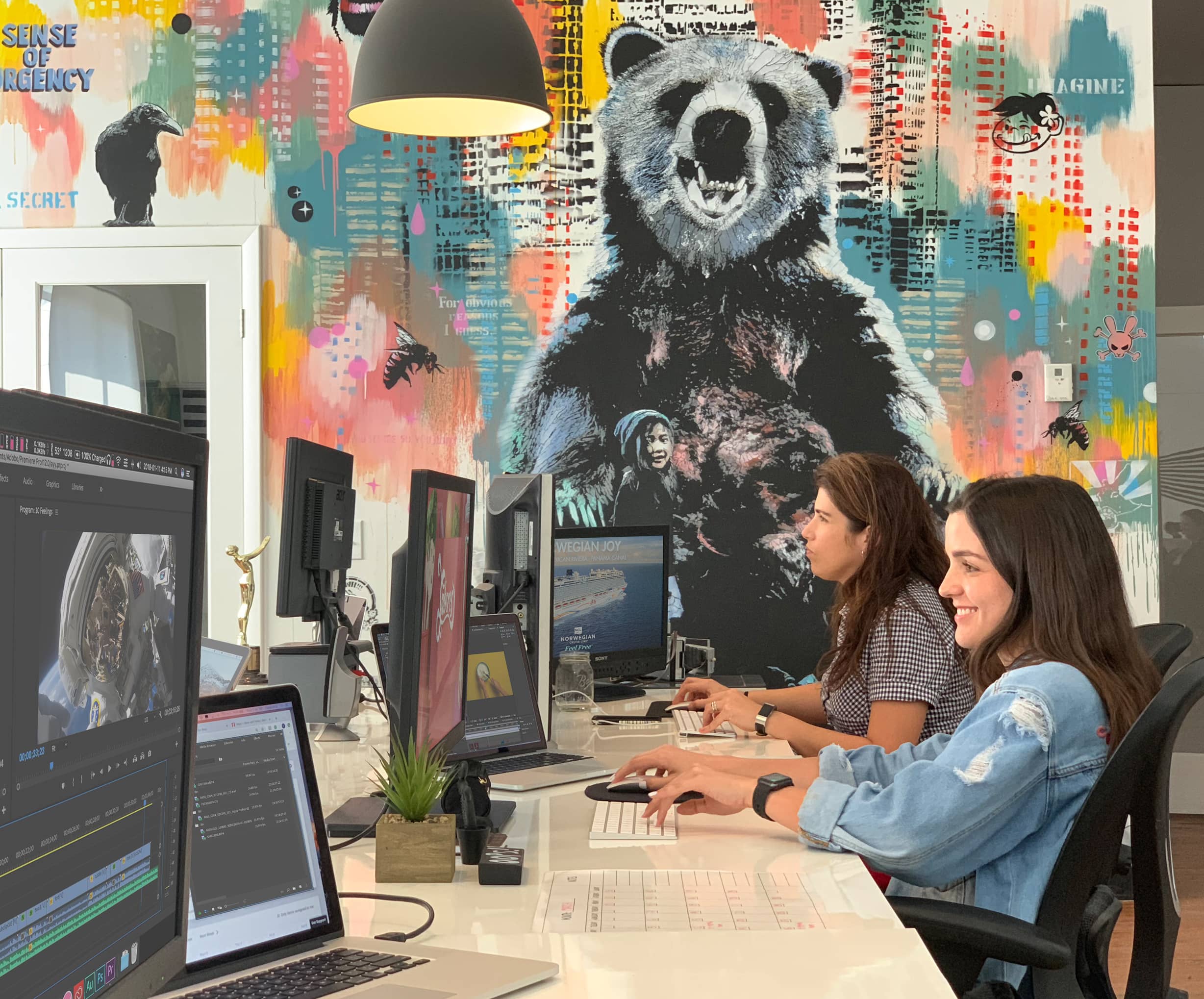 Ingrid Ruiz and a colleague work on computer workstations at Think Twice studio office